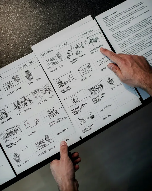 Hands walking through a sketched storyboard, frame by frame