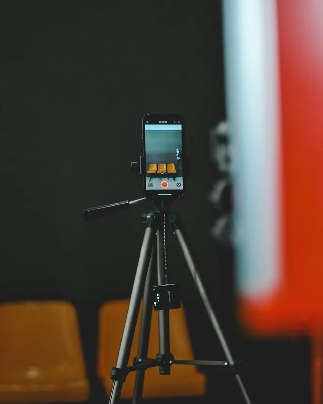 A phone on a tripod, set up to record a short video
